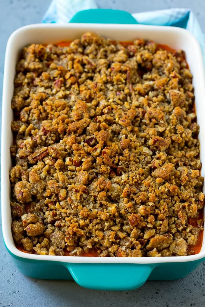Ruth's Chris Sweet Potato Casserole Recipe | Sweet Potato Casserole | Mashed Sweet Potatoes #sweetpotatoes #casserole #thanksgiving #christmas #holidays #dinner #sadud #sidedish A baking dish of Ruth's Chris sweet potato casserole topped with streusel.