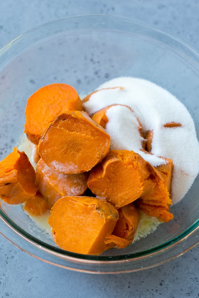 Ruth's Chris Sweet Potato Casserole Recipe | Sweet Potato Casserole | Mashed Sweet Potatoes #sweetpotatoes #casserole #thanksgiving #christmas #holidays #dinner #sadud #sidedish Sweet potatoes, sugar and butter in a bowl.