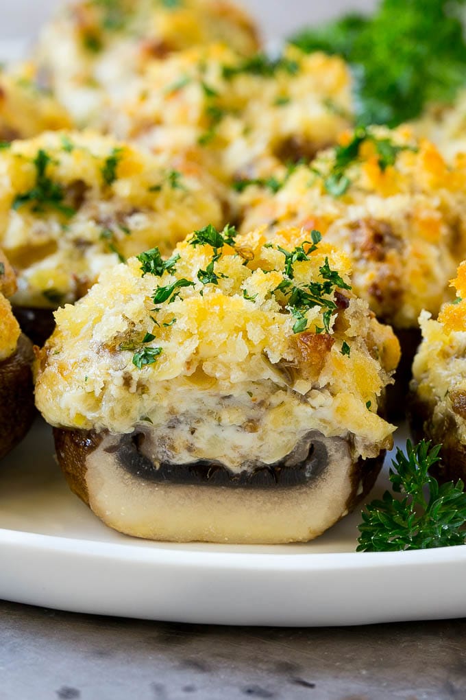Sausage Stuffed Mushrooms Recipe | Stuffed Mushrooms | Mushroom Appetizer #mushrooms #sausage #appetizer #lowcarb #keto #sadud A cross section of a sausage stuffed mushroom on a serving platter.