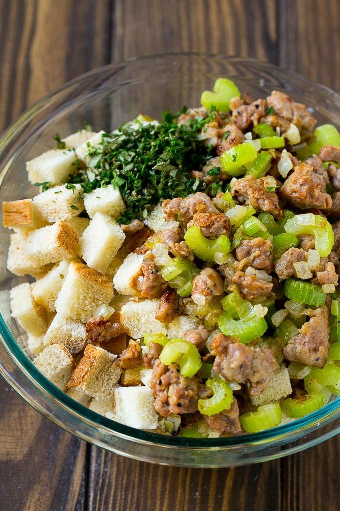 Sausage Stuffing Recipe | Thanksgiving Stuffing | Make Ahead Stuffing #stuffing #thanksgiving #sausage #sidedish #dinner #sadud Meat, sauteed vegetables and bread cubes in a mixing bowl.