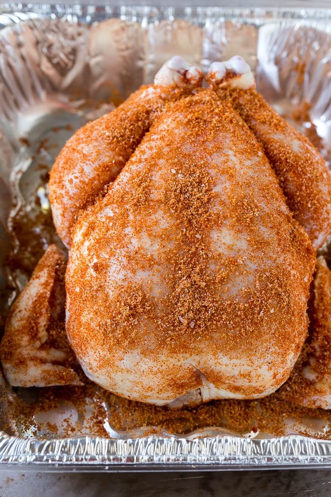 Smoked Chicken Recipe | Whole Smoked Chicken | BBQ Chicken #chicken #smoker #BBQ #dinner #sadud #glutenfree #lowcarb A raw bird is coated with homemade spice rub in a roasting pan.