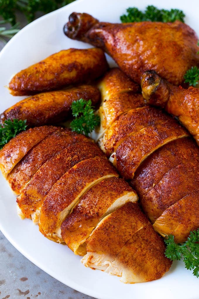 Smoked Chicken Recipe | Whole Smoked Chicken | BBQ Chicken #chicken #smoker #BBQ #dinner #sadud #glutenfree #lowcarb Carved smoked chicken including drumsticks, wings and chicken breasts on a serving platter.