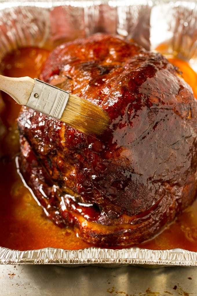 Brown Sugar Smoked Ham Recipe | Holiday Ham Recipe | Brown Sugar Glazed Ham #ham #christmas #thanksgiving #easter #smoker #dinner #brownsugar #sadud #glutenfree Brown sugar glaze brushed on the pork.