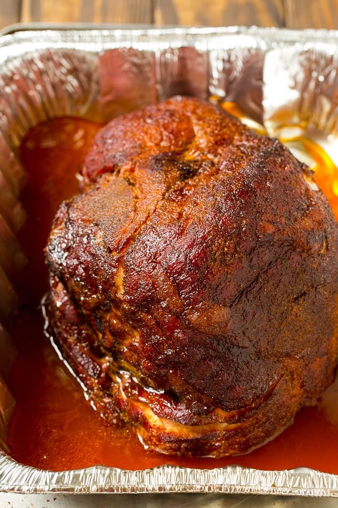 Brown Sugar Smoked Ham Recipe | Holiday Ham Recipe | Brown Sugar Glazed Ham #ham #christmas #thanksgiving #easter #smoker #dinner #brownsugar #sadud #glutenfree BBQ rub coating the meat.