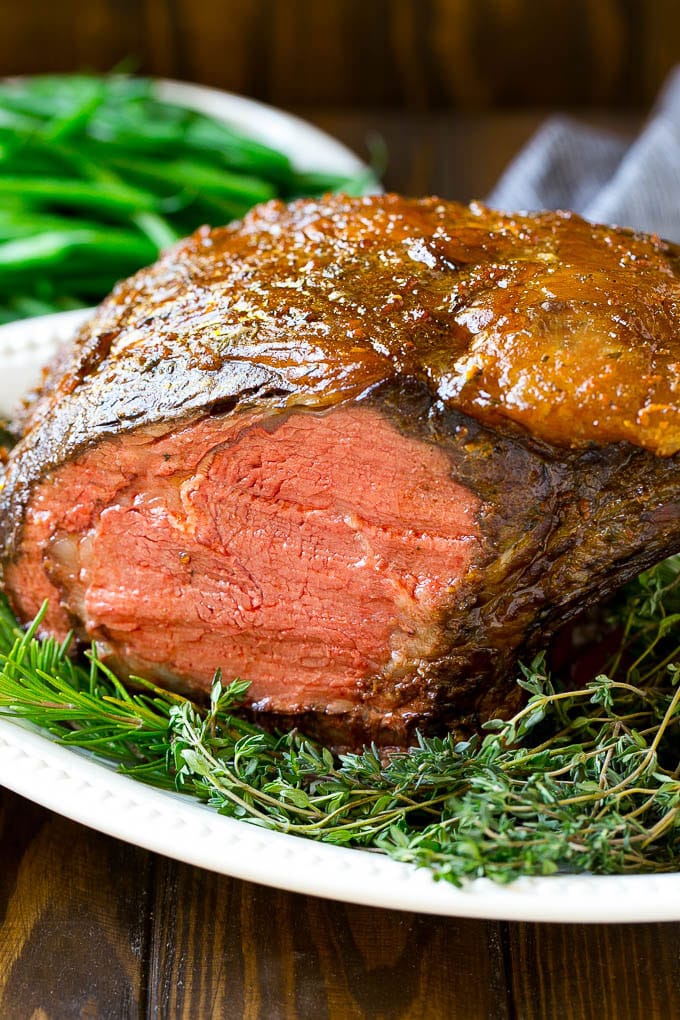 Smoked Prime Rib Recipe | Easy Prime Rib | Smoked Beef | Holiday Prime Rib #primerib #beef #smoker #dinner #sadud #christmas #thanksgiving #lowcarb #keto A smoked prime rib roast cooked to medium rare on a serving platter.