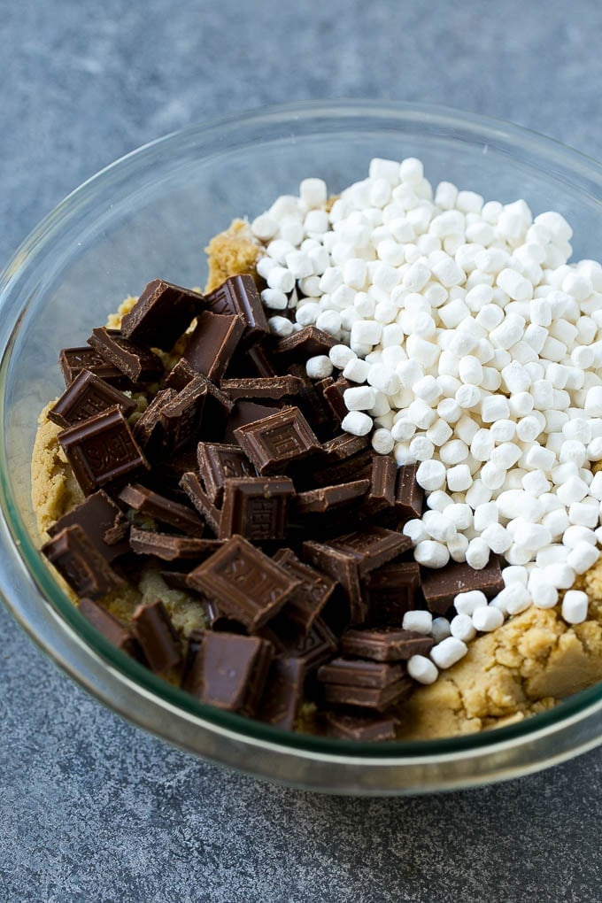 S'mores Cookies Recipe | Marshmallow Cookies #smores #marshmallow #chocolate #cookies #dessert #sadud Graham cracker cookie dough with marshmallow bits and milk chocolate.