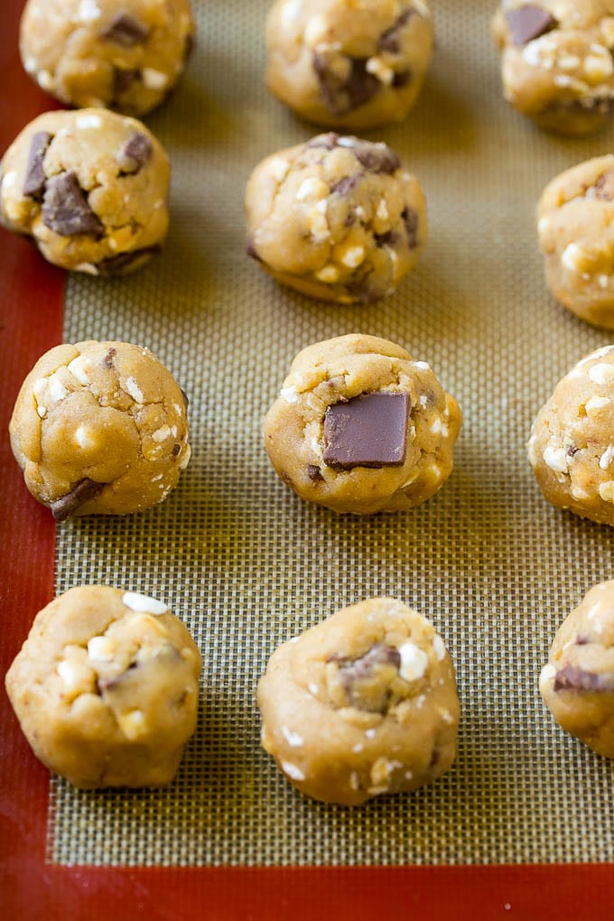 S'mores Cookies Recipe | Marshmallow Cookies #smores #marshmallow #chocolate #cookies #dessert #sadud Balls of cookie dough on a baking sheet.