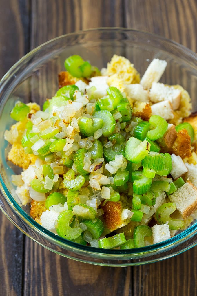 This old fashioned Southern cornbread dressing recipe is a classic that's a must-have for every Thanksgiving table. It's made with celery, onions, homemade cornbread, white bread and plenty of herbs. Bread cubes, cornbread and sauteed celery and onions in a bowl.