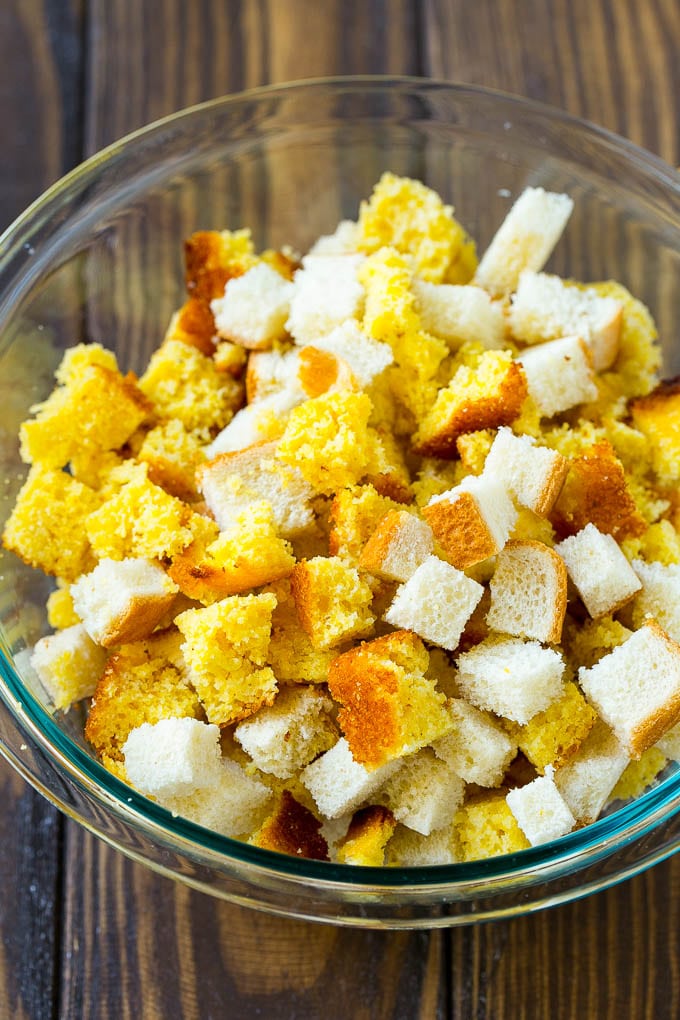 This old fashioned Southern cornbread dressing recipe is a classic that's a must-have for every Thanksgiving table. It's made with celery, onions, homemade cornbread, white bread and plenty of herbs. Cornbread and white bread cubes in a mixing bowl.