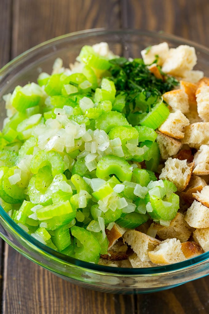 Turkey Stuffing Recipe | Thanksgiving Stuffing | Classic Stuffing #thanksgiving #stuffing #sidedish #fall #sadud Bread cubes, celery, onion and herbs in a mixing bowl.