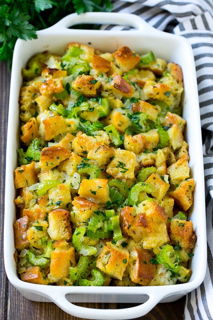 Turkey Stuffing Recipe | Thanksgiving Stuffing | Classic Stuffing #thanksgiving #stuffing #sidedish #fall #sadud Baked turkey stuffing in a dish topped with fresh parsley.