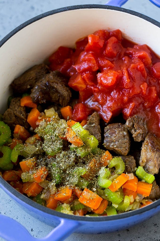 Vegetable Beef Soup Recipe | Beef Vegetable Soup | Beef Soup #beef #veggies #soup #dinner #glutenfree #sadud Stew meat, veggies, tomatoes and herbs in a pot.