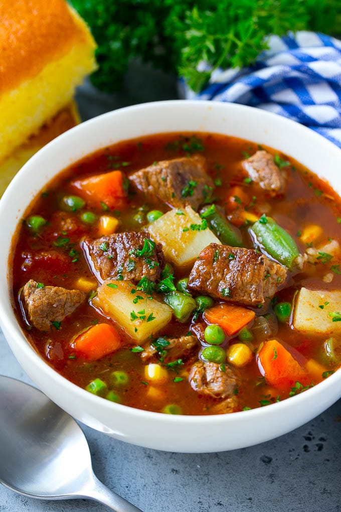 Vegetable Beef Soup Recipe | Beef Vegetable Soup | Beef Soup #beef #veggies #soup #dinner #glutenfree #sadud A bowl of vegetable beef soup with carrots, celery, onions, potatoes, tomatoes, corn and peas.
