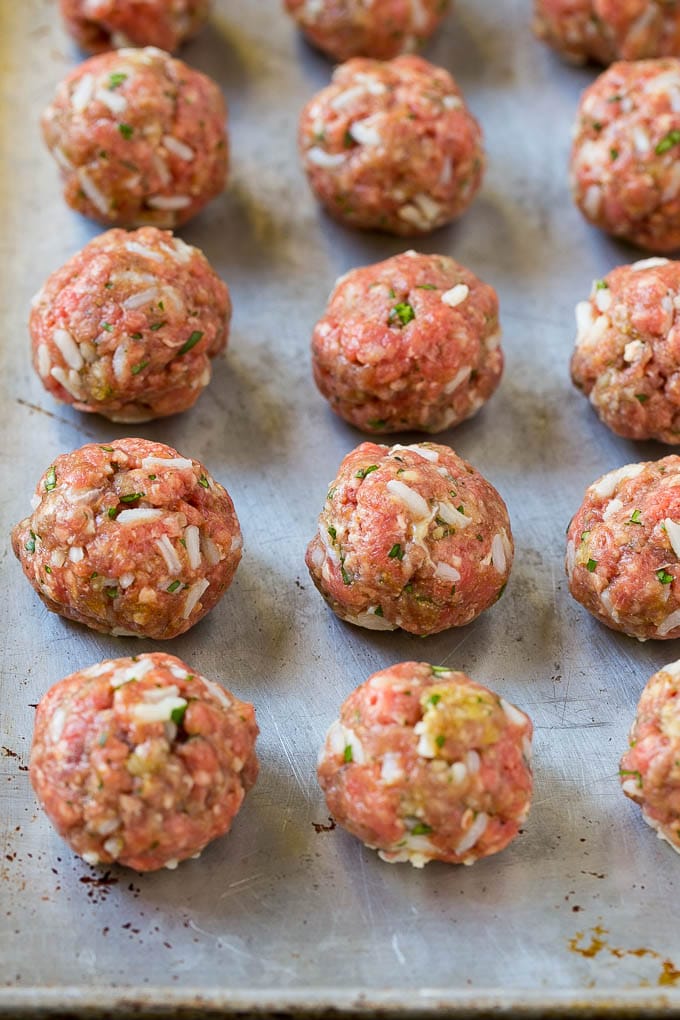Albondigas Soup | Meatball Soup | Mexican Soup #soup #meatballs #beef #rice #glutenfree #dinner #sadud #comfortfood Uncooked beef and rice meatballs on a sheet pan.