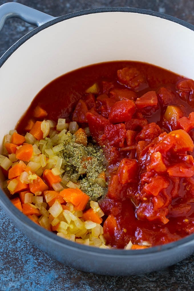 Albondigas Soup | Meatball Soup | Mexican Soup #soup #meatballs #beef #rice #glutenfree #dinner #sadud #comfortfood Vegetables, tomatoes and herbs in a soup pot.