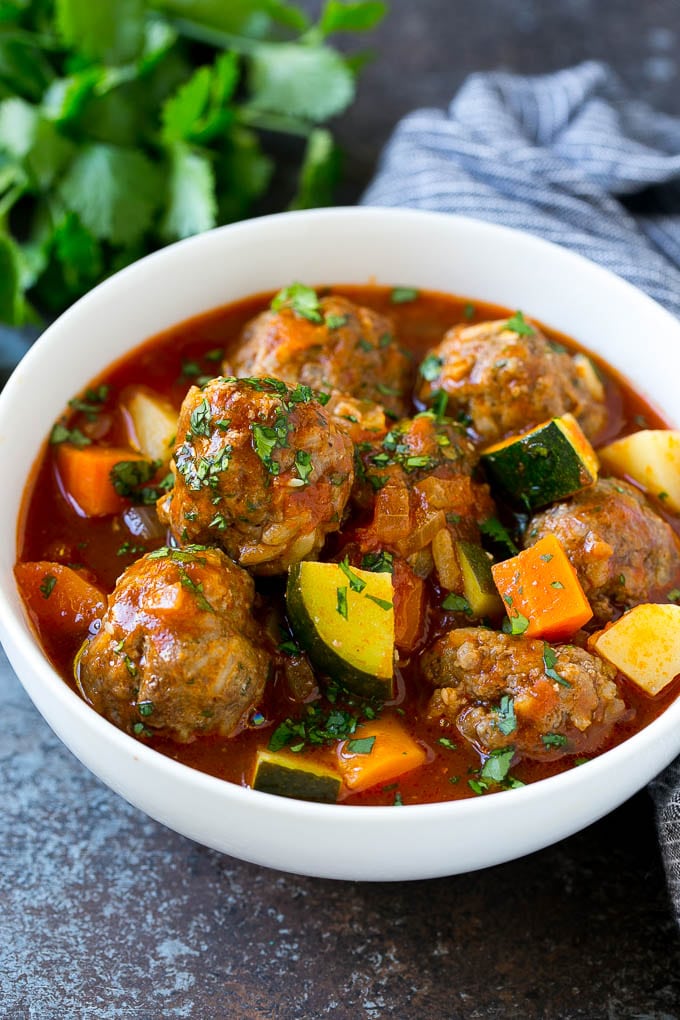 Albondigas Soup | Meatball Soup | Mexican Soup #soup #meatballs #beef #rice #glutenfree #dinner #sadud #comfortfood A bowl of albondigas soup with meatballs, carrots, zucchini and tomatoes.