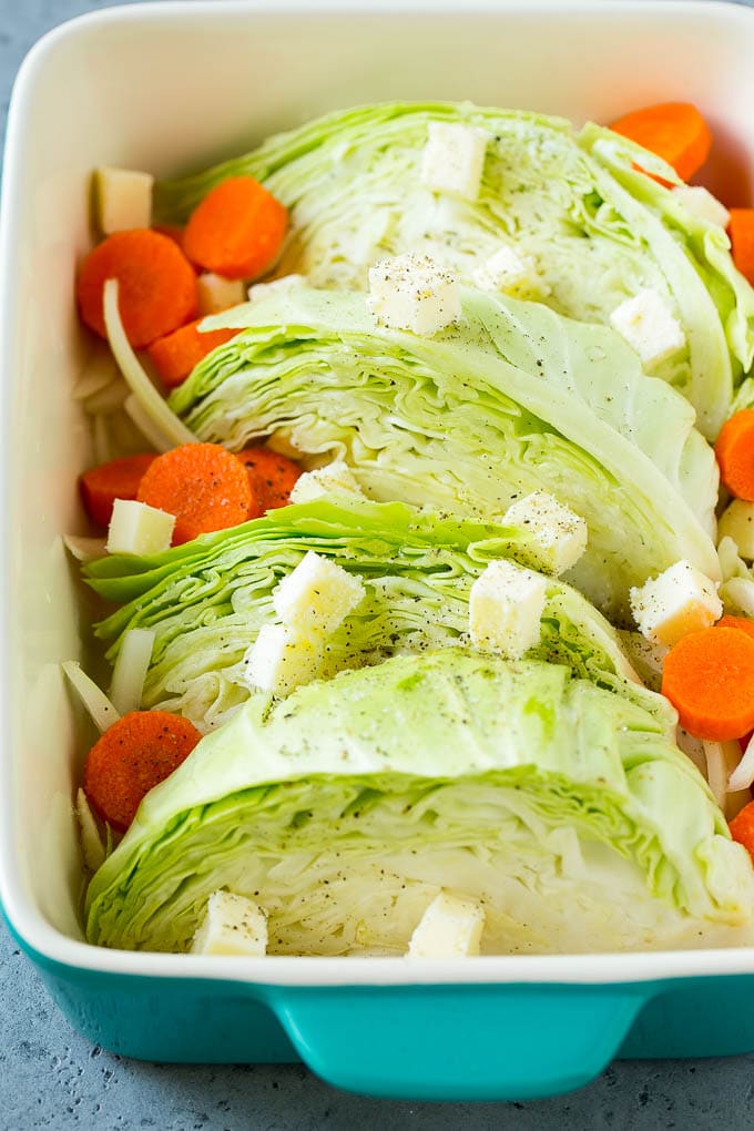 Braised Cabbage Recipe | Easy Cabbage Recipe #cabbage #lowcarb #keto #carrots #veggies #vegetarian #dinner #sadud Cabbage, carrots, onions, pieces of butter and seasonings in a baking dish.