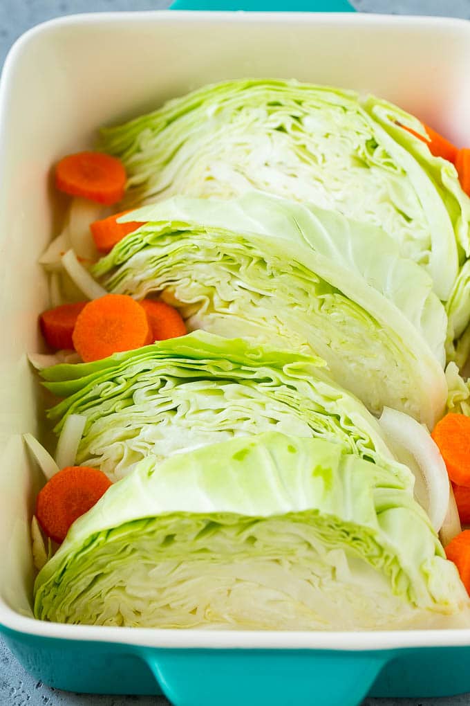 Braised Cabbage Recipe | Easy Cabbage Recipe #cabbage #lowcarb #keto #carrots #veggies #vegetarian #dinner #sadud Wedges of cabbage, sliced carrots and onion in a baking dish.
