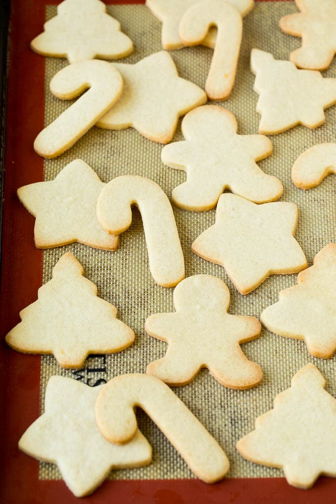 Christmas Sugar Cookies Recipe | Christmas Cookies #cookies #frosting #sprinkles #sugarcookies #christmas #dessert #sadud Cut out cookies on a sheet pan.