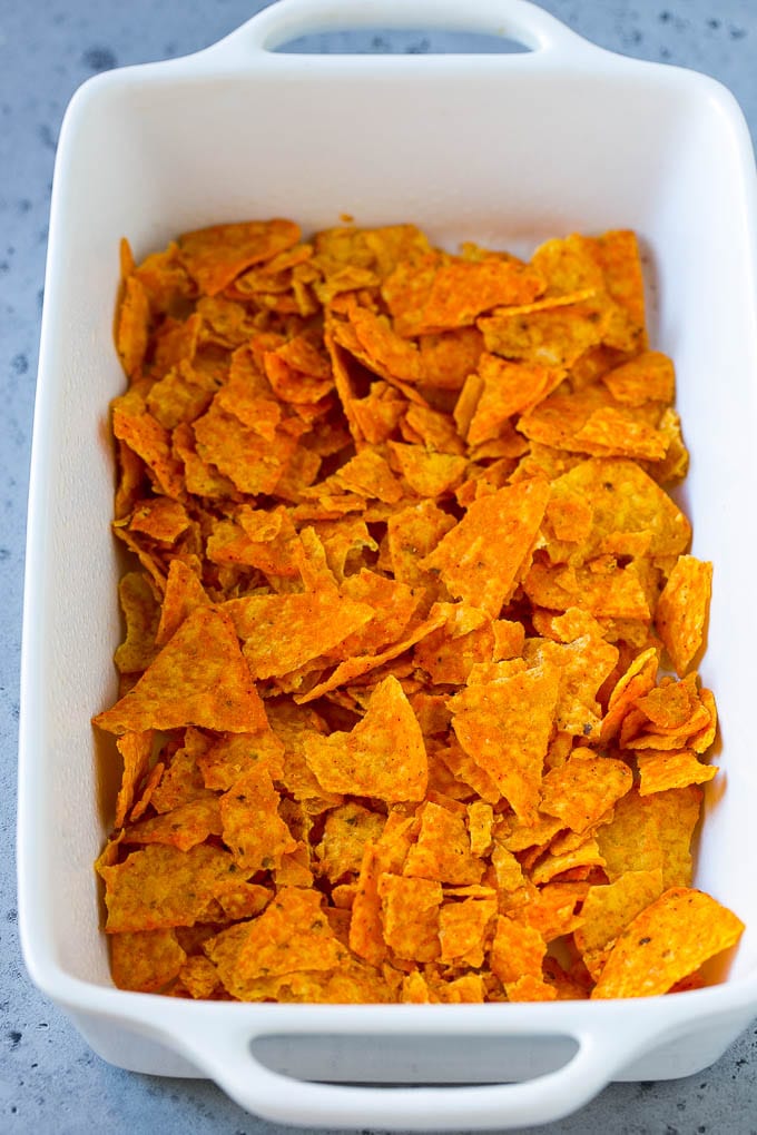 Dorito Casserole Recipe | Mexican Casserole | Beef Casserole #mexicanfood #beef #groundbeef #casserole #dinner #sadud Crushed nacho chips in the bottom of a casserole dish.