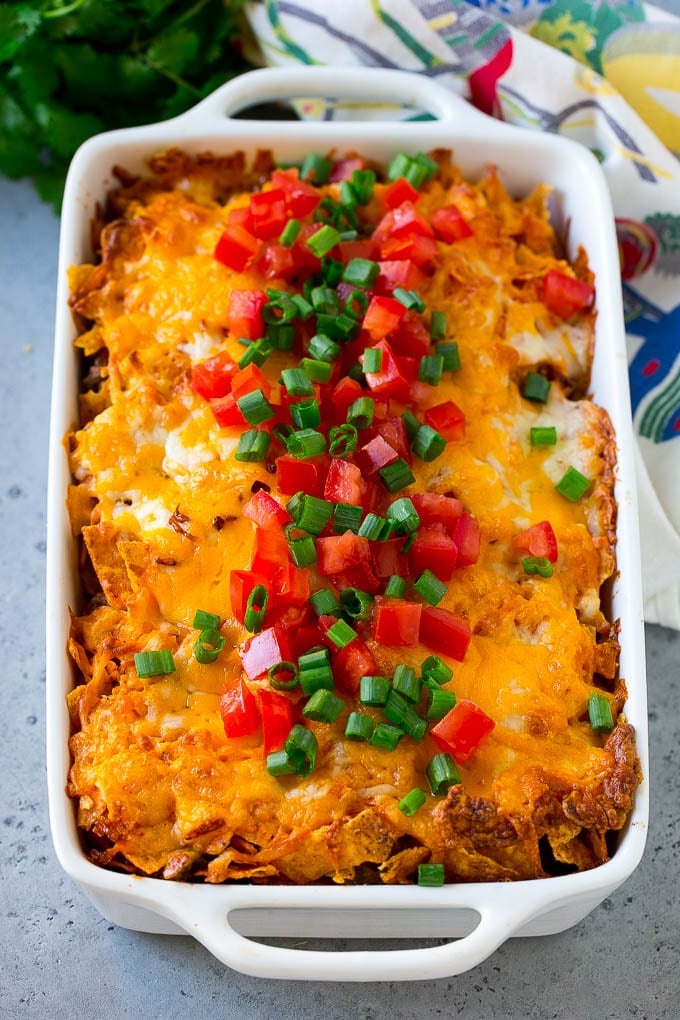 Dorito Casserole Recipe | Mexican Casserole | Beef Casserole #mexicanfood #beef #groundbeef #casserole #dinner #sadud Dorito casserole topped with melted cheese, diced tomatoes and sliced green onions.