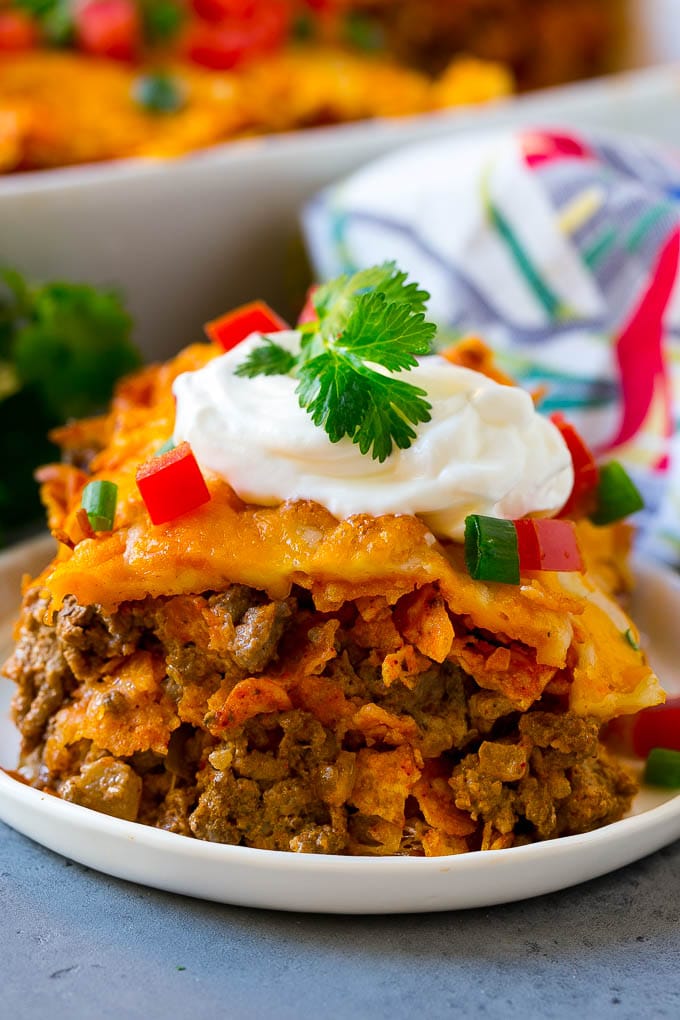 Dorito Casserole Recipe | Mexican Casserole | Beef Casserole #mexicanfood #beef #groundbeef #casserole #dinner #sadud A piece of Dorito casserole with layers of tortilla chips, beef and cheese.