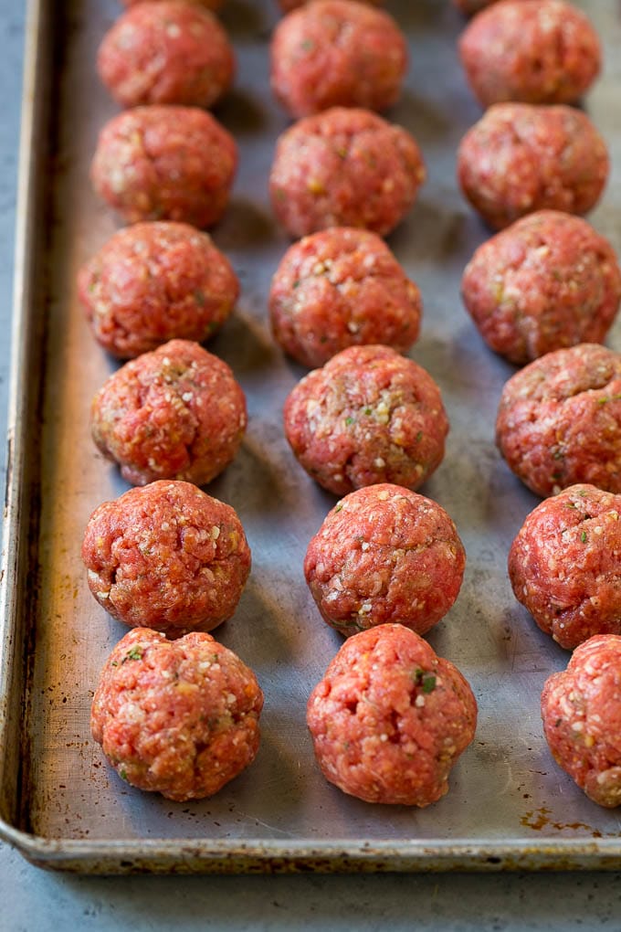 Italian Meatball Soup Recipe | Meatball Soup | Beef Meatballs #meatballs #beef #soup #italian #dinner #sadud #comfortfood Raw meatballs on a sheet pan ready to go into the oven.