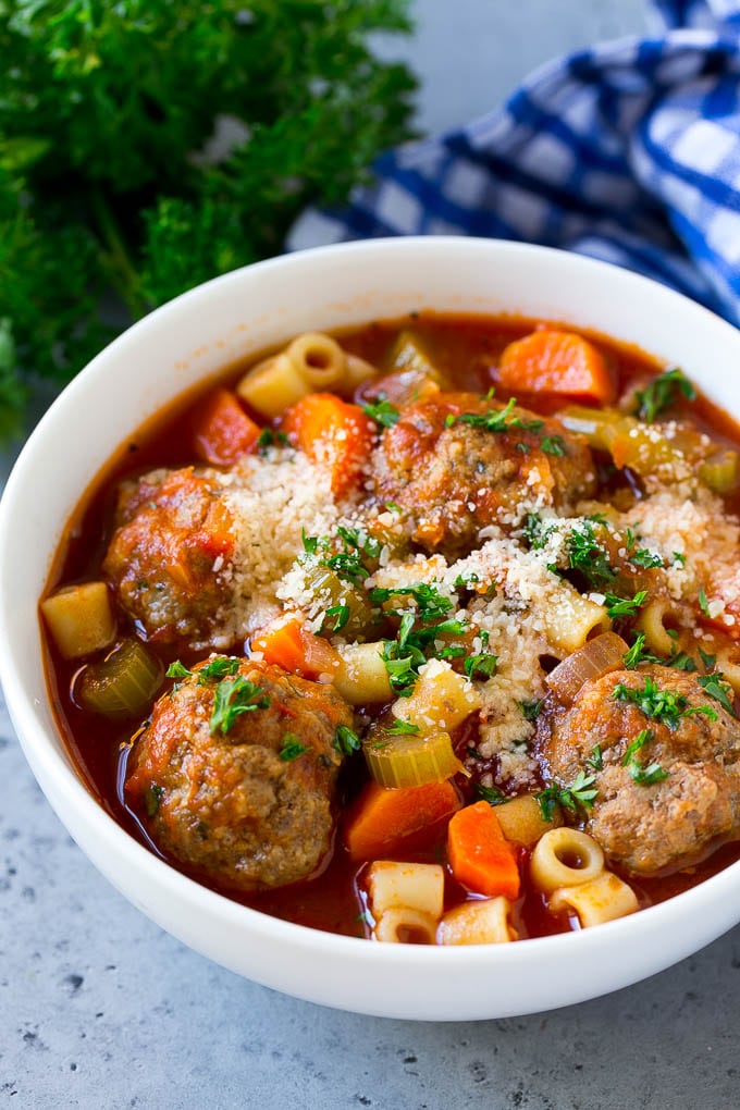 Italian Meatball Soup Recipe | Meatball Soup | Beef Meatballs #meatballs #beef #soup #italian #dinner #sadud #comfortfood A bowl of meatball soup topped with chopped parsley and grated cheese.