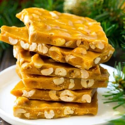 Peanut brittle stacked onto a serving plate.