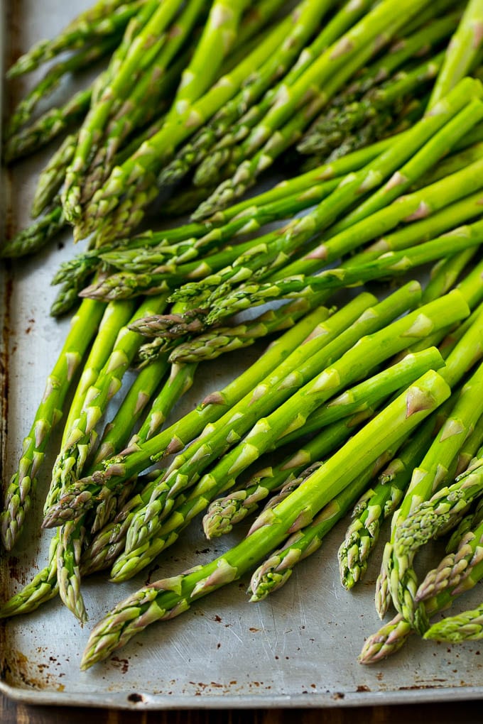 Roasted Asparagus Recipe | Baked Asparagus | Asparagus Side Dish #asparagus #garlic #sidedish #keto #lowcarb #dinner #sadud Raw asparagus spears on a sheet pan.