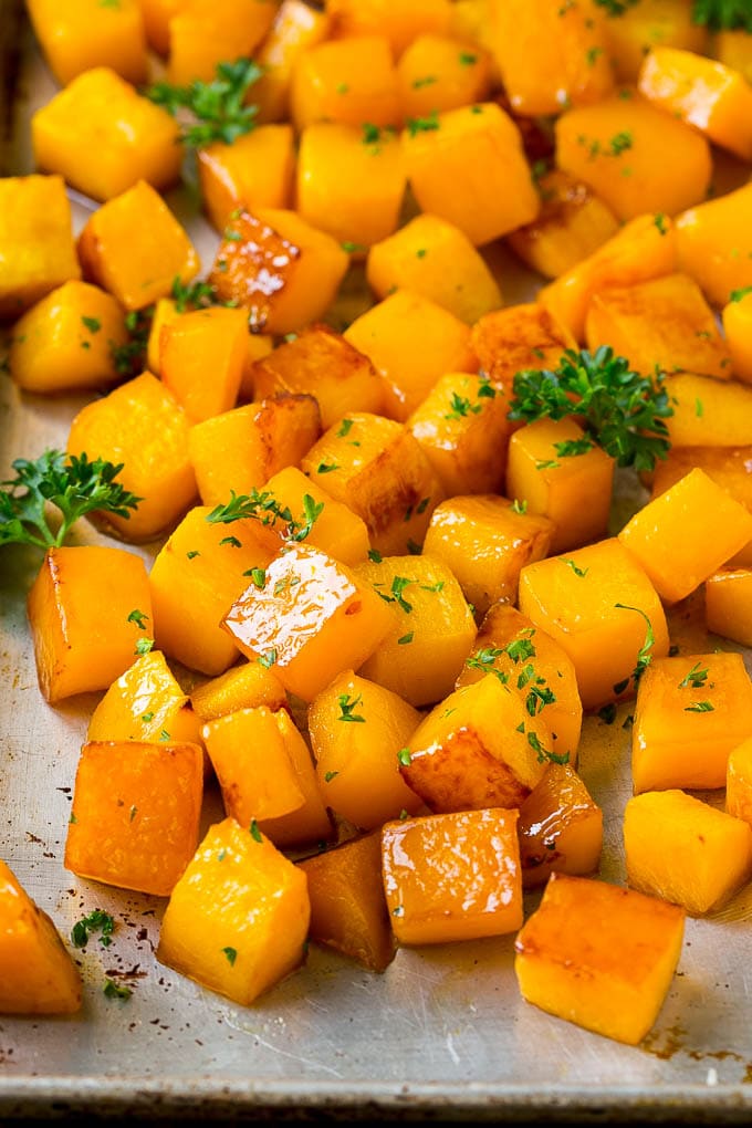 Roasted Butternut Squash Recipe | Baked Butternut Squash | Butternut Squash Side Dish #butternutsquash #squash #fall #vegetarian #dinner #sadud Roasted butternut squash with brown sugar and maple syrup, garnished with chopped parsley.