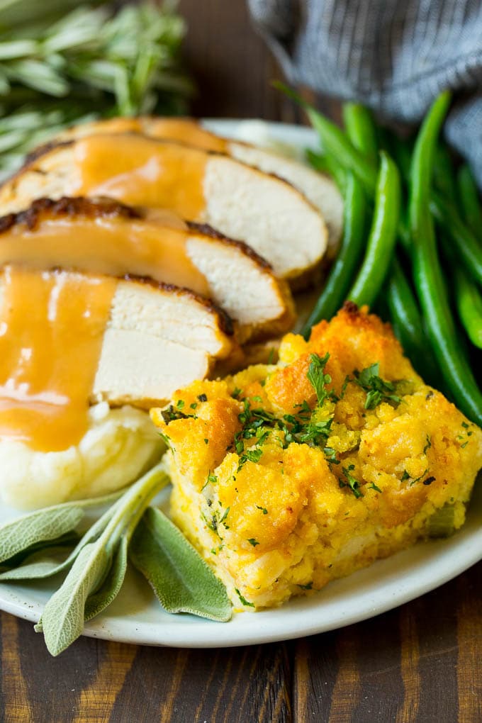 This old fashioned Southern cornbread dressing recipe is a classic that's a must-have for every Thanksgiving table. It's made with celery, onions, homemade cornbread, white bread and plenty of herbs. Cornbread stuffing served with turkey and green beans.