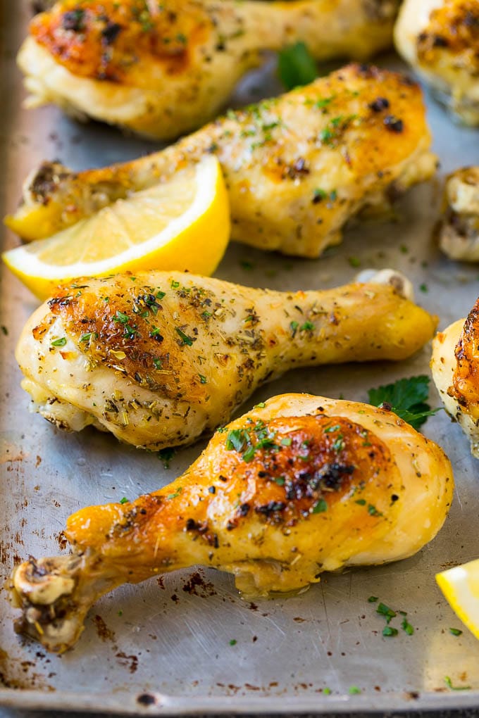 Baked Chicken Drumsticks Recipe | Roasted Chicken Drumsticks | Garlic and Herb Chicken #dinner #chicken #garlic #glutenfree #lowcarb #keto #cleaneating #sadud Baked chicken drumsticks flavored with garlic and herbs, then garnished with lemon wedges and parsley.