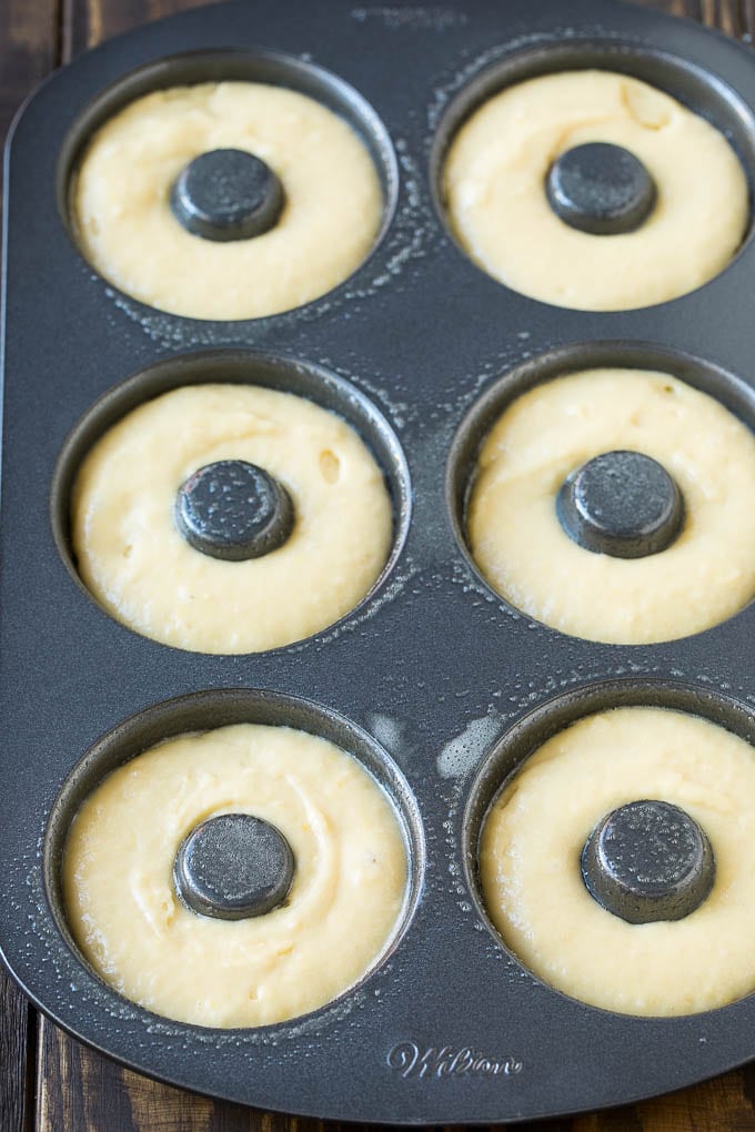 Baked Donuts Recipe | Cake Donuts | Chocolate Donuts | Sprinkle Donuts #donuts #chocolate #sprinkles #breakfast #brunch #sadud A donut pan filled with dough.