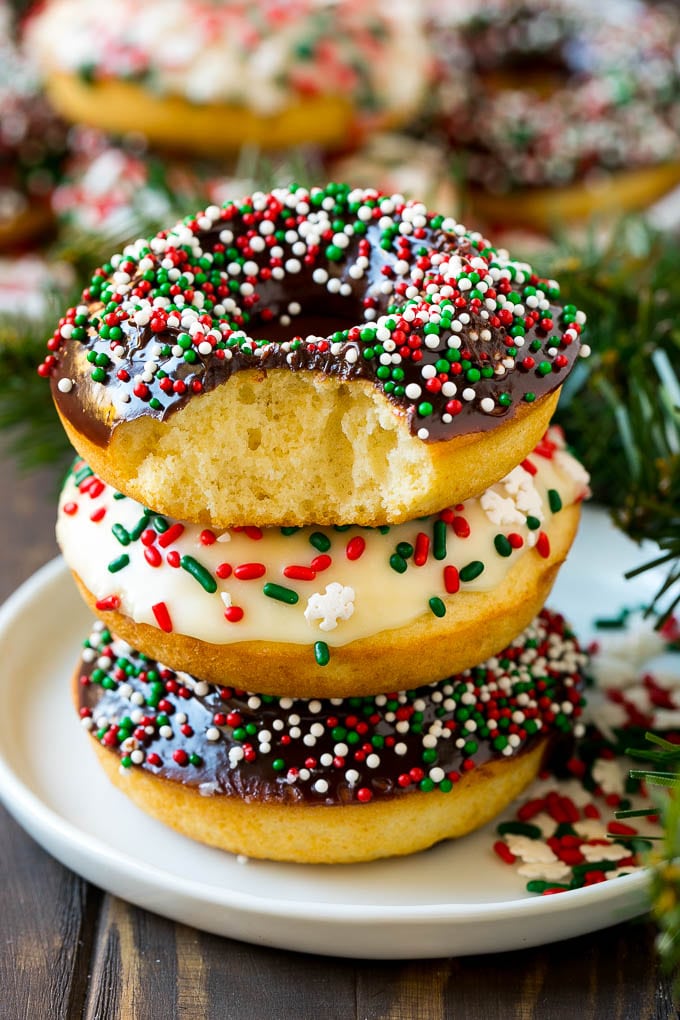 Baked Donuts Recipe | Cake Donuts | Chocolate Donuts | Sprinkle Donuts #donuts #chocolate #sprinkles #breakfast #brunch #sadud A stack of donuts with a bite out of one.