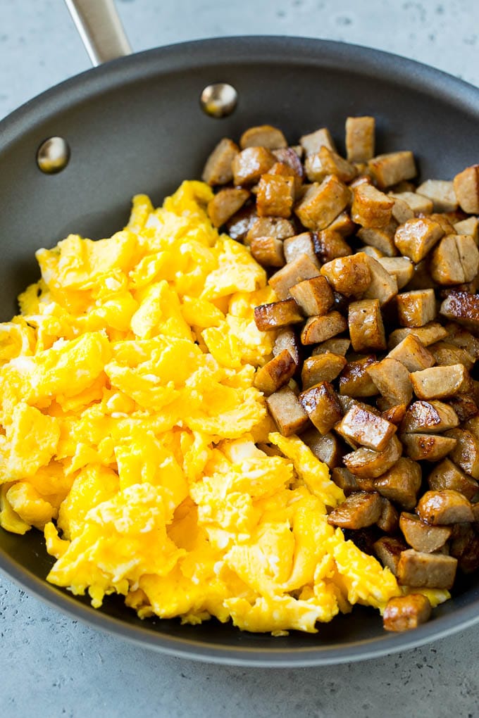 Breakfast Burrito Recipe | Sausage Breakfast Burrito #breakfast #sausage #eggs #burrito #sadud Diced sausage and scrambled eggs in a pan.