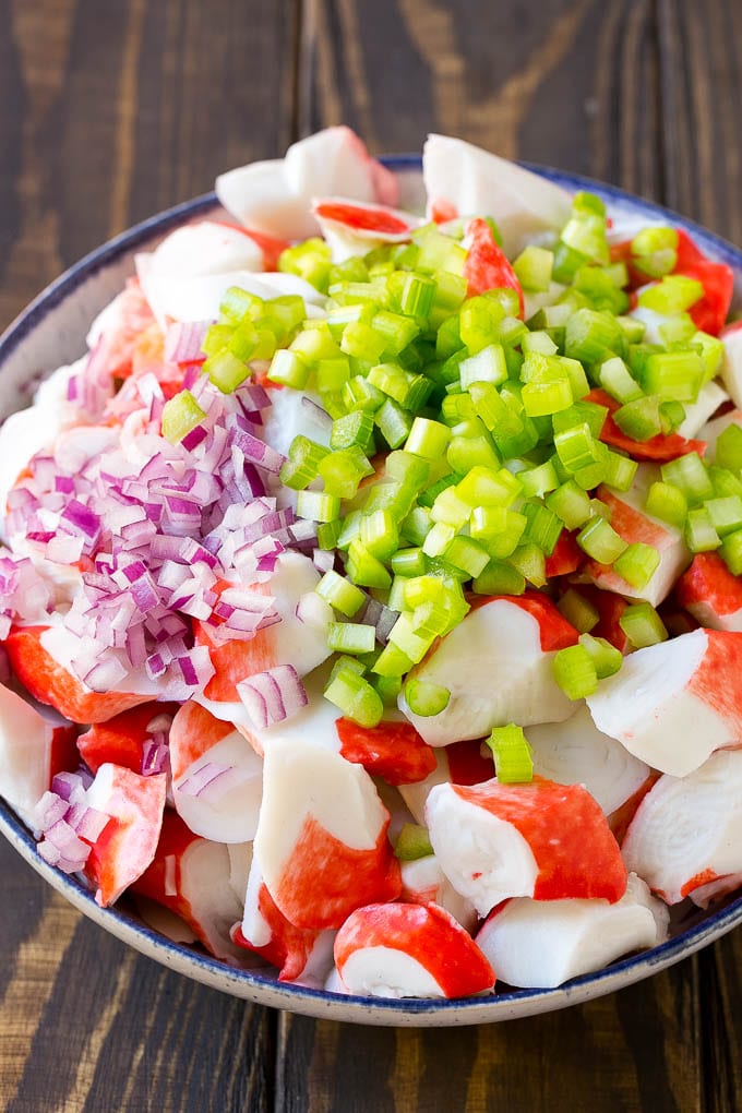 Crab Salad Recipe | Seafood Salad | Deli Salad #crab #salad #seafood #lowcarb #keto #lunch #dinner #sadud Imitation crab, celery and red onion in a serving bowl.