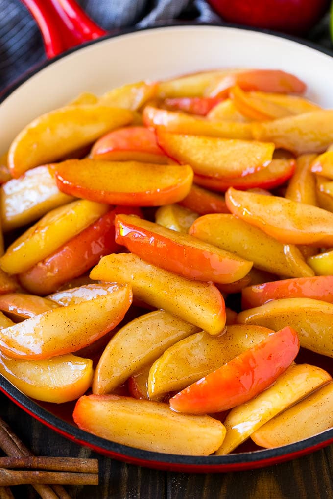 Fried Apples Recipe | Sauteed Apples | Cinnamon Sugar Apples #apples #cinnamon #sugar #sidedish #dessert #sadud #fall Southern fried apples coated in butter, cinnamon and sugar in a red skillet.