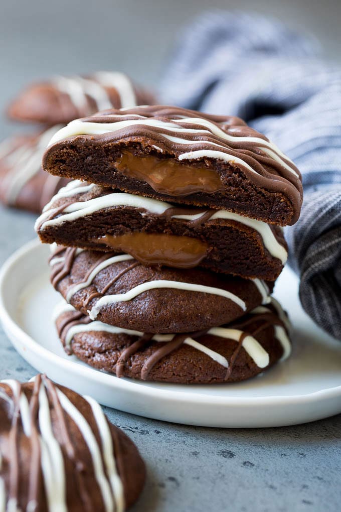 Nutella Cookies Recipe | Nutella Stuffed Cookies | Chocolate Cookies #nutella #chocolate #cookies #baking #dessert #sadud A stack of Nutella cookies on a plate with one cut open.