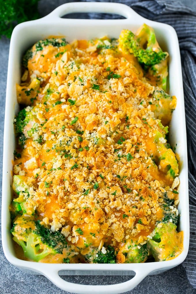 Broccoli Casserole Recipe | Broccoli and Cheese Casserole | Baked Broccoli #broccoli #cheese #casserole #sidedish #dinner #sadud A pan of broccoli casserole topped with crackers, melted cheese and parsley.