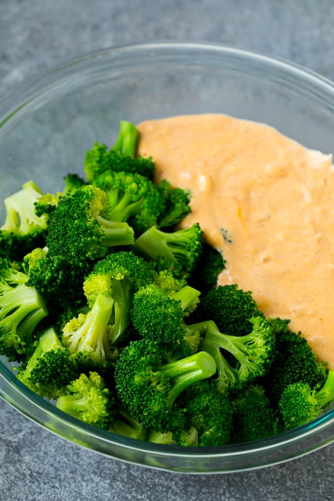 Broccoli Casserole Recipe | Broccoli and Cheese Casserole | Baked Broccoli #broccoli #cheese #casserole #sidedish #dinner #sadud Cooked florets and cheese sauce in a mixing bowl.