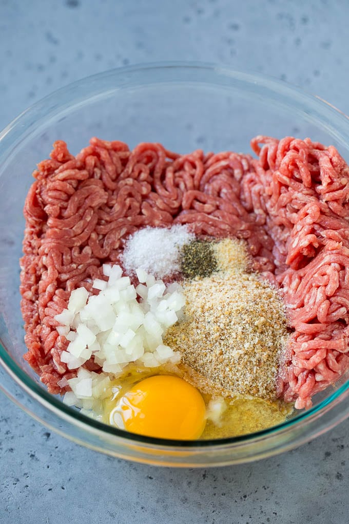 Sweet and Sour Meatballs Recipe | Slow Cooker Meatballs | Crockpot Meatballs | Cocktail Meatballs #meatballs #beef #slowcooker #crockpot #dinner #appetizer #sadud Ground beef, onion, breadcrumbs and seasonings in a bowl.