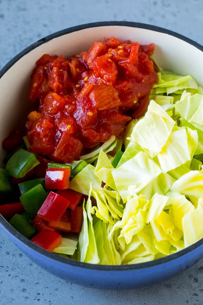 Cabbage Soup Recipe | Vegetable Soup | Veggie Soup | Healthy Soup #soup #healthy #cleaneating #cabbage #vegetables #veggies #dinner #sadud Red and green peppers, diced tomatoes and raw veggies in a large pot.