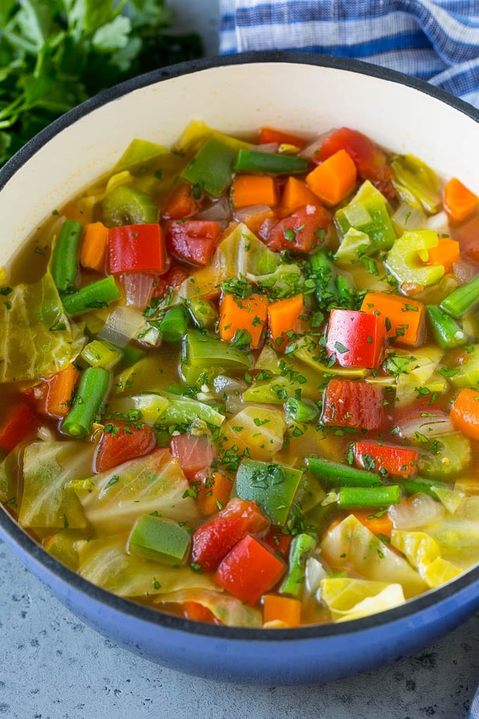 Cabbage Soup Recipe | Vegetable Soup | Veggie Soup | Healthy Soup #soup #healthy #cleaneating #cabbage #vegetables #veggies #dinner #sadud A pot of cabbage soup with carrots, celery, bell peppers and green beans.