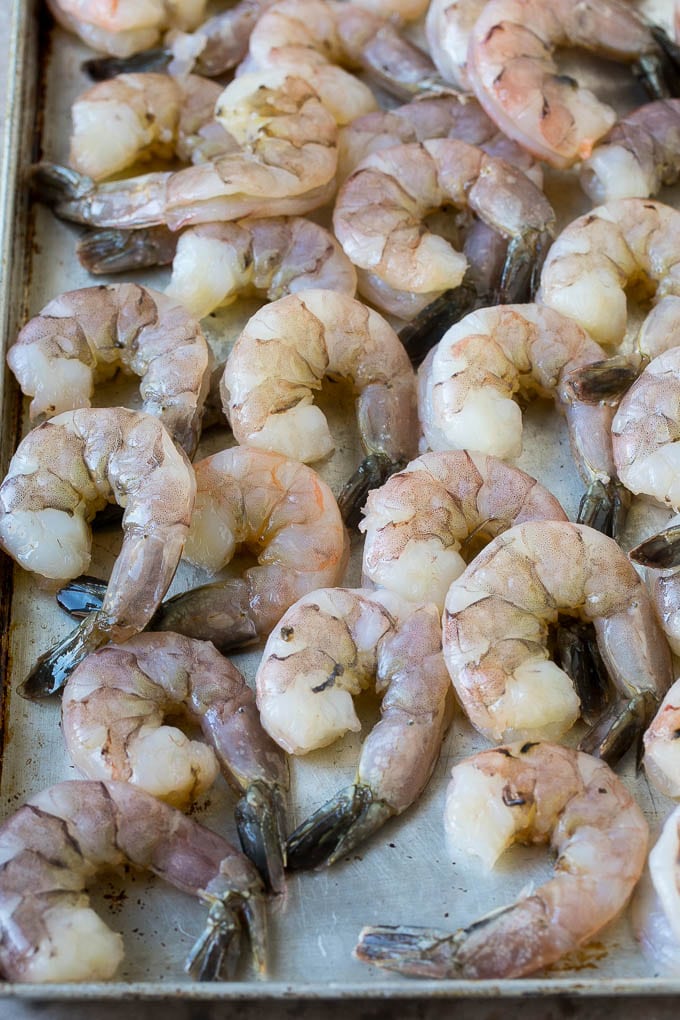 Coconut Shrimp Recipe | Fried Shrimp | Shrimp Appetizer #shrimp #coconut #appetizer #seafood #dinner #sadud Large raw tail-on shrimp arranged on a sheet pan.