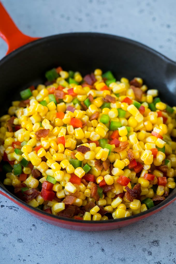 Corn Dip Recipe | Hot Cheese Dip | Bacon Dip #corn #dip #bacon #cheese #appetizer #snack #sadud Corn, bacon and bell peppers in a skillet.
