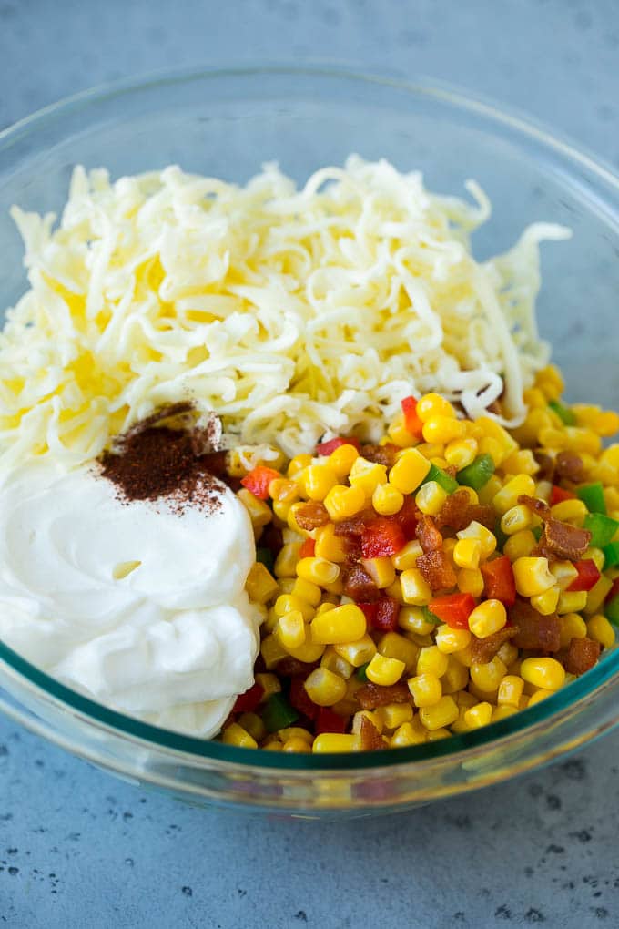 Corn Dip Recipe | Hot Cheese Dip | Bacon Dip #corn #dip #bacon #cheese #appetizer #snack #sadud Corn, bacon, bell peppers, sour cream and cheese in a mixing bowl.