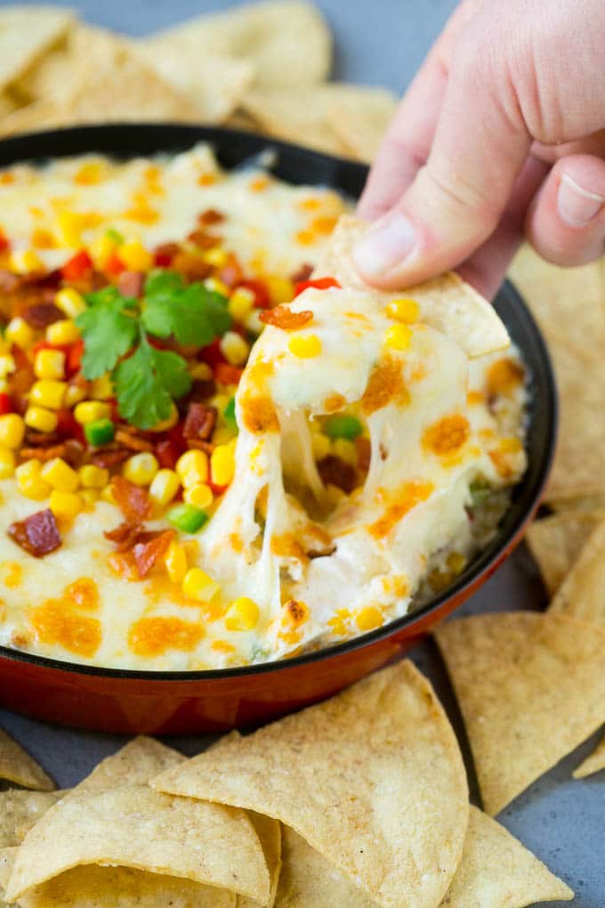 Corn Dip Recipe | Hot Cheese Dip | Bacon Dip #corn #dip #bacon #cheese #appetizer #snack #sadud A chip scooping up a serving of corn dip.