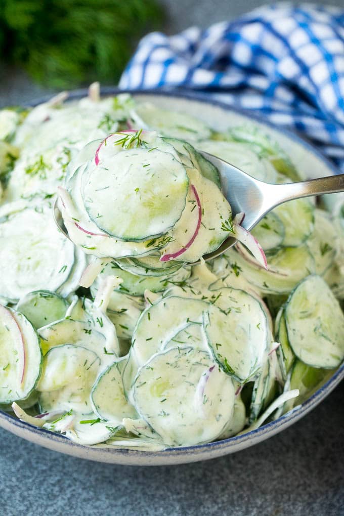 Creamy Cucumber Salad Recipe | German Cucumber Salad | Cucumber Salad #cucumber #salad #dinner #lunch #sadud #cucumbersalad A spoon serving up a portion of creamy cucumber salad.