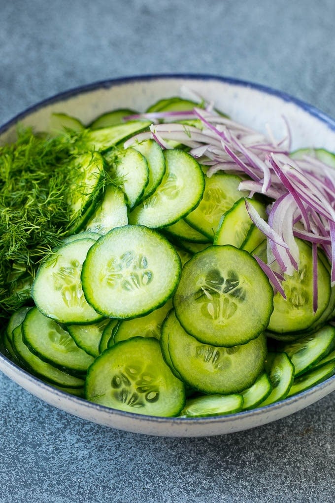 Cucumber Salad Recipe | Cucumber Dill Salad | Cucumber Recipe #cucumbers #salad #glutenfree #sidedish #sadud Ingredients including red onion and dill in a bowl.